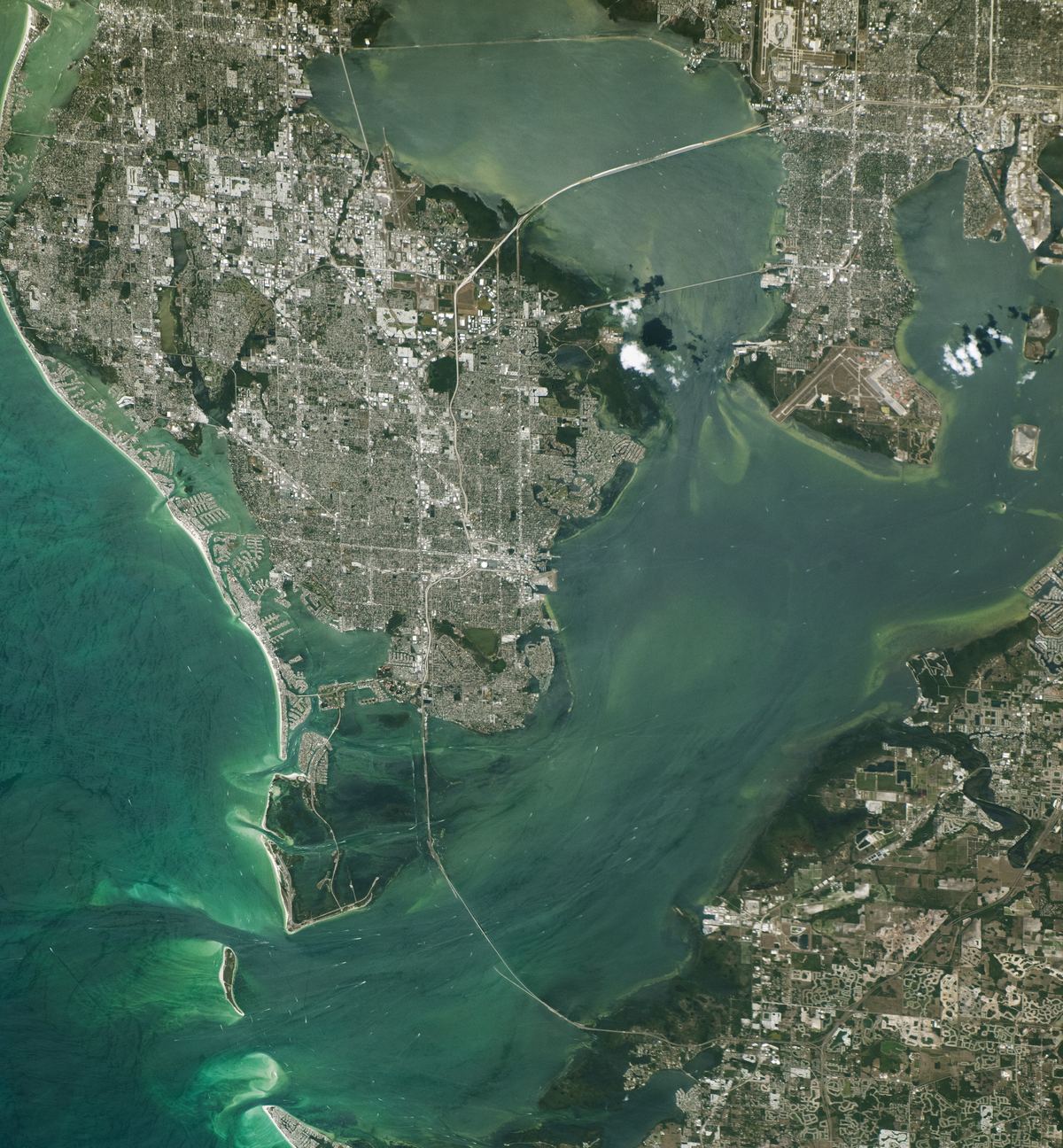 Astronaut photograph of Tampa Bay from the International Space Station, showing the Pinellas peninsula and Gulf beaches, St. Petersburg, the Sunshine Skyway Bridge crossing the bay, and Tampa